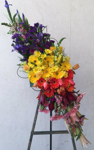 ETERNAL FLAME - ON SALE WAS $190 - THE ETERNAL FLAME. ONE OF OUR CUSTOMERS FAVORITE  A BEAUTIFUL ARRAY OF COLOR ,FILLES WITH IRIS, GERBERS, ROSES, LILIES. SITS ON A 5 FOOT EASEL 