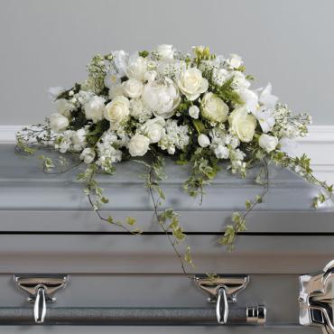 Loving Memories Casket Spray -   A pure white, loving tribute created with roses, iris, tulips, carnations and tenderly trailing ivy. 