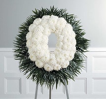 CIRCLE OF LIFE - RESPRESENTS THE CIRCLE OF LIFE. A WONDERFUL PIECE FILLED WITH WHITE CARNATIONS AND ACCENTED WTH RICH GREENS.  DISPLAYED ON A FIVE FOOT EASEL.