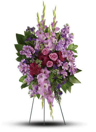 Lavender Reflections Spray -   Take a walk through the garden of memories with this lush spray of lavender and purple blooms, accented with fresh green ti leaves. It's a joyful expression of sympathy sure to be appreciated.  This regal spray includes lavender roses, lavender alstroemeria, lavender gladioli, lavender stock, purple cushion spray chrysanthemums, purple sinuata statice, green ti leaves, flat cedar, oregonia and lemon leaf. 