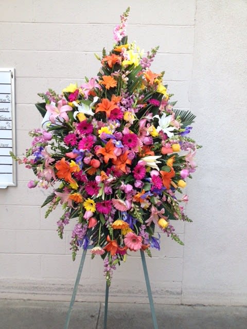 AMAZING LIFE EASEL - CELEBRATE THIER LIFE WITH THIS STUNNING BEAUTY OF VIVID COLORS .  FLOWERS TO INCLUDE IMPORTED ROSES, STARGAZER LILIES, SNAPDRAGONS, GERBERAS AND MORE.  BIG AND BEAUTIFUL.  SITS ON A FIVE FOOT EASEL 