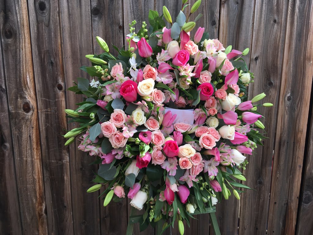 VICTORIAN EASEL VICTORIAN EASEL - SEND THIS BEAUTIFUL VICTORIAN STYLE WREATH TO EXPRESS YOUR COMPASSION DURING A DIFFICULT TIME. A BEAUTIFUL DISPLAY OF PURE WHITE AND PINK TONES OF IMPORTED ROSES, LISANTHUIS, ORCHIDS SILVER DOLLAR EUC, AND MORE, ARTISTICALLY ARRANGED. SITS ON A FIVE FOOT EASEL.
