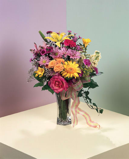 ON SALE WAS $82- LOVING FLORAL EMBRACE VASE ON SALE WAS $82- LOVING FLORAL EMBRACE VASE - BRIGHT AND COLORFUL ARRAY OF IMPORTED ROSES, GERBERS, SNAPS AND MORE, ACCENTED WITH A BOW