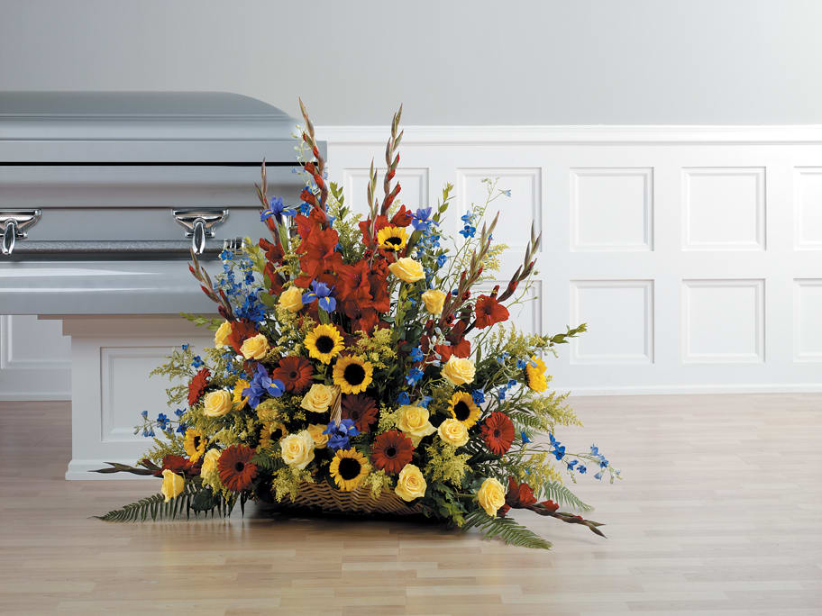 FLORAL TREASURE FUNERAL SPRAY - A BEAUTIFUL LARGE ARRAY OF COLOR, FEATURING SUNFLOWERS.