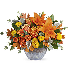 Teleflora's Golden Bounty Centerpiece - Make the season shine with this golden fall bounty of roses and lilies, arranged in a gorgeous oven-to-table ceramic bowl. It's finished with an eye-catching artisanal glaze in shades of steel blue--the perfect mix of pretty and practical!