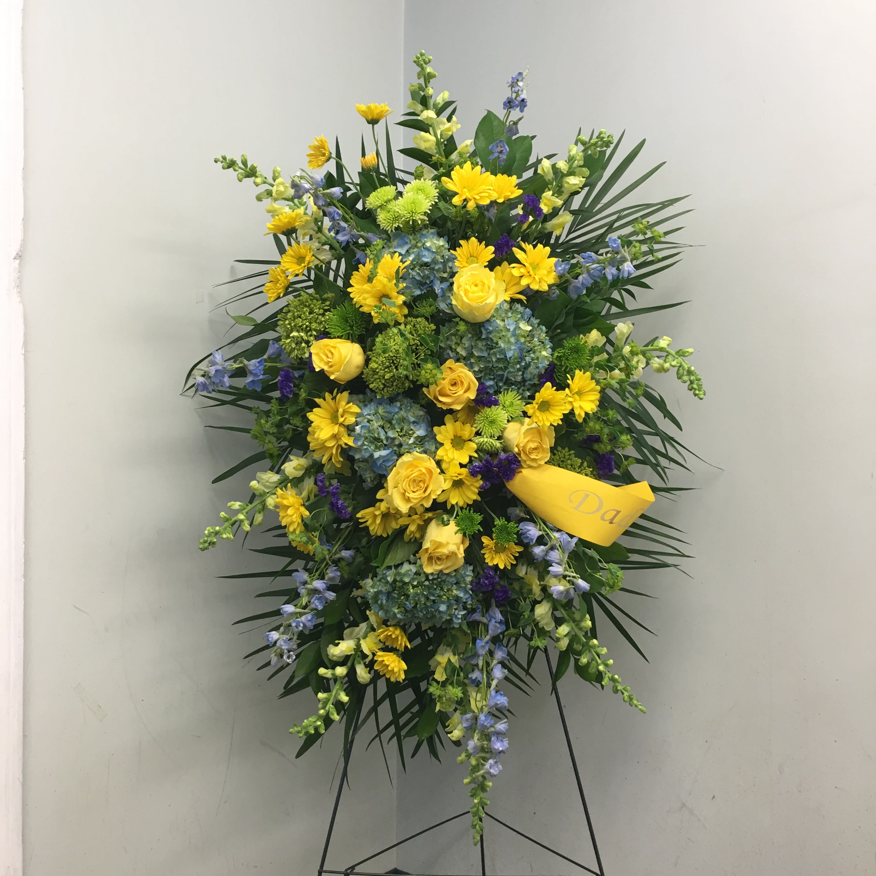 Evans Blue Green & Yellow Funeral Spray by Evans Flowers ...