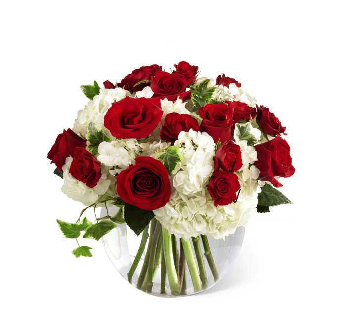 The FTD Our Love Eternal Bouquet - The FTD Our Love Eternal Bouquet is a symbol of unending love and affection in the time of great loss. Brilliant red roses and spray roses pop against a bed of white hydrangea simply accented with stems of variegated ivy and beautifully arranged in a clear glass bubble bowl to create a wonderful way to convey your deepest sympathies.