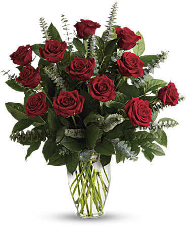 Eternal Love Bouquet - What's more romantic than a dozen red roses? Proclaim your love eternal with this radiant gift of crimson blooms and fresh greens gathered in a classic keepsake vase.