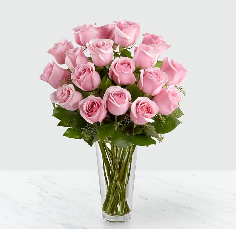 The Long Stem Pink Rose Bouquet - VASE INCLUDED - Picture-perfect soft pink roses make a beautiful gift for the lovely lady in your life. Wife, mother, daughter or sweetheart, she's sure to cherish this bouquet of pastel pink roses accented with seeded eucalyptus and arranged in a clear glass vase.  