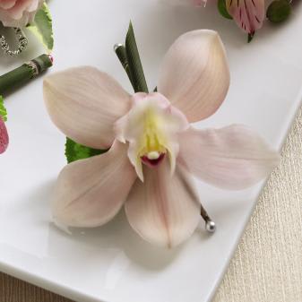 FTD Pink Cymbidium Boutonniere - The FTDÂ® Pink Cymbidium Boutonniere brings a fresh elegance to the look   of your wedding party. A single Cymbidium Orchid bloom is secured to an   equisetum stem and accented with a cyclamen leaf to bring a simple style   of blushing sophistication to your big day. Approx. 4âH x 4âW.   