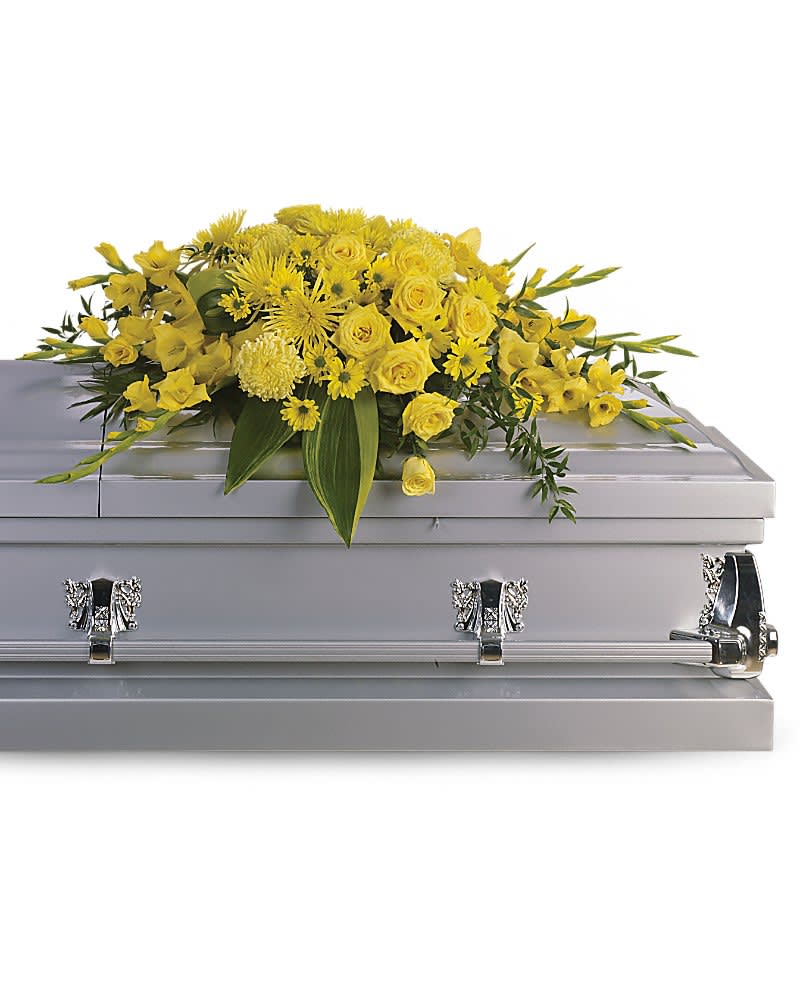 Graceful Grandeur Casket Spray - Joyous times and golden memories are recalled with this lovely half-couch casket spray that consoles the bereaved with a sunny array of beautiful blooms. A bevy of yellow blossoms such as roses gladioli chrysanthemums and more are perfectly arranged in this lovely casket spray.