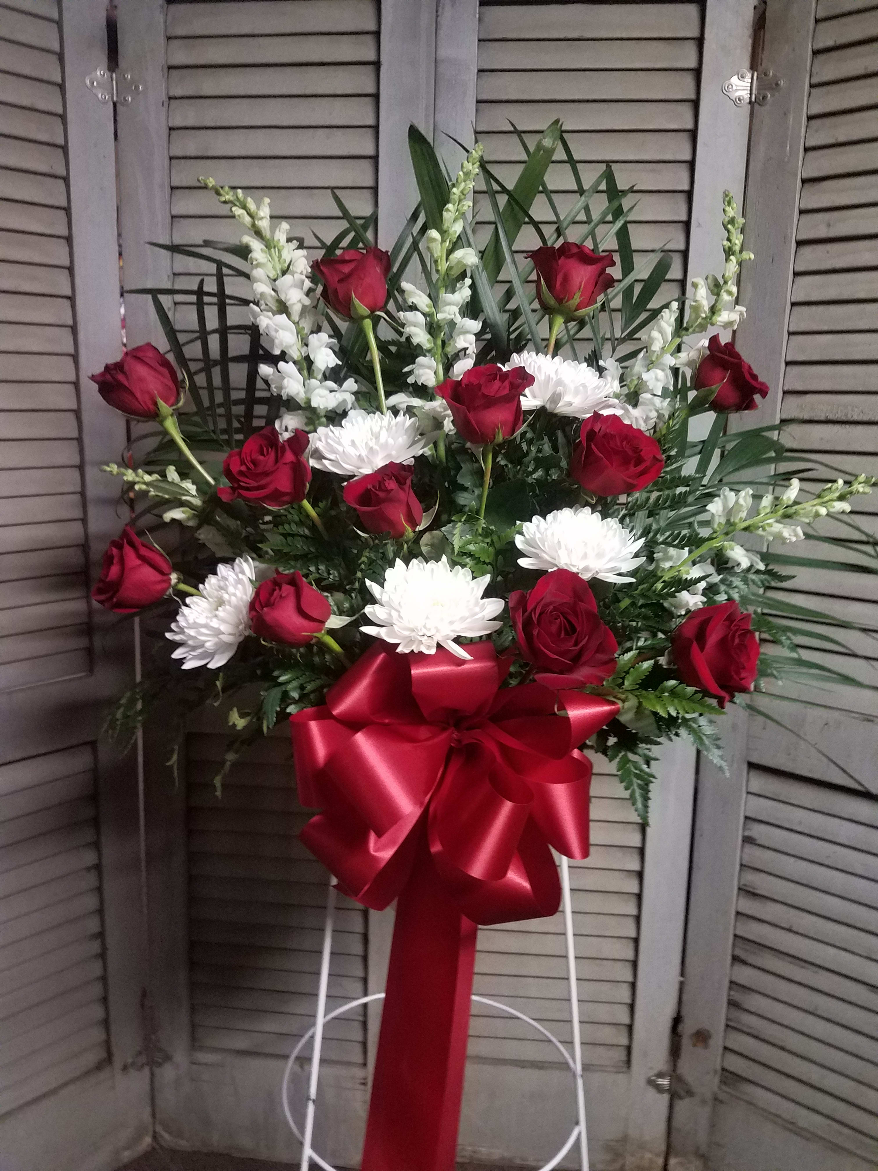 Red and White mache basket - A stunning display with red roses and other white flowers in our standing mache basket with hi onor, love, and remembrance.