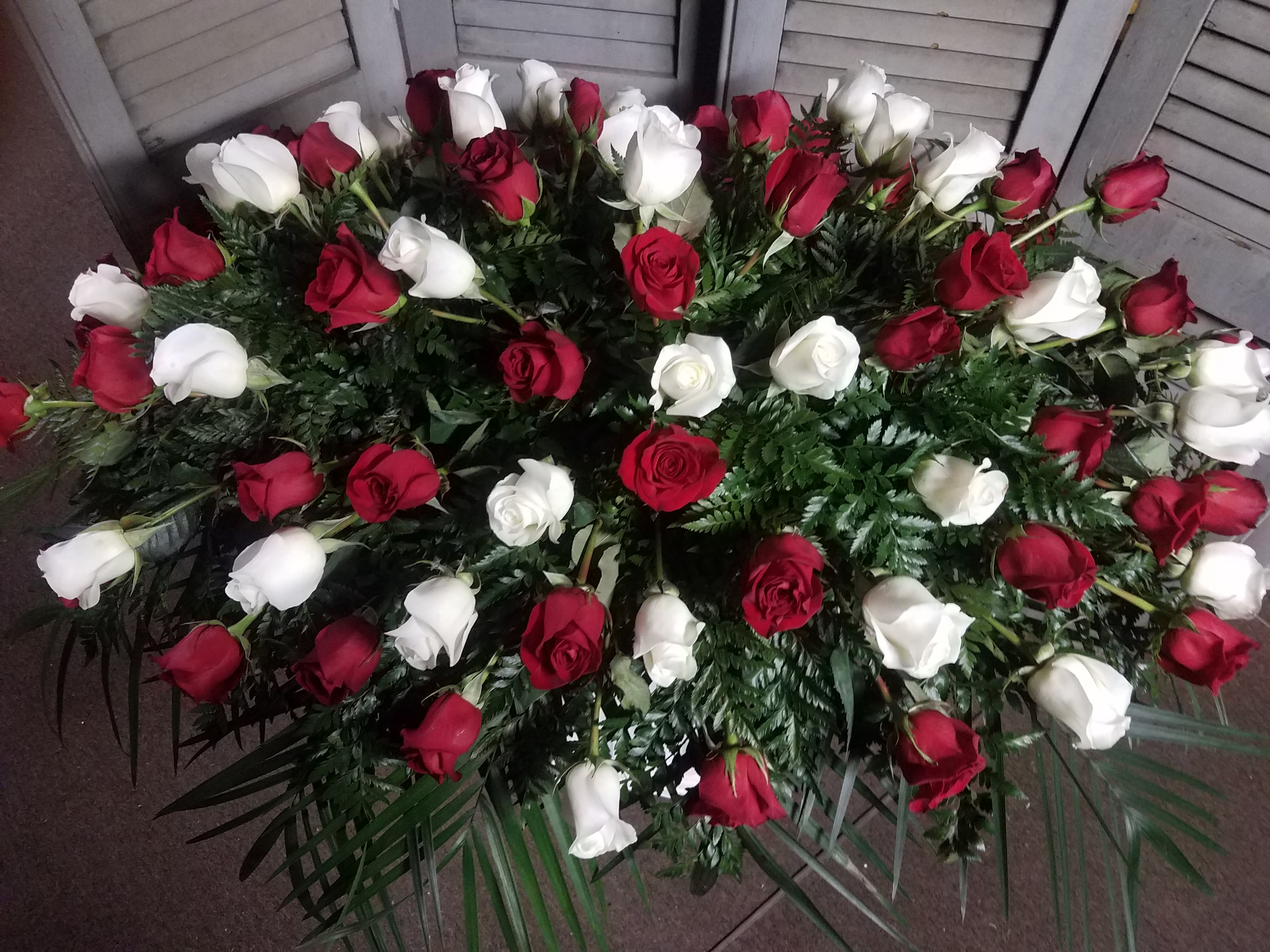 Red and white casket spray in roses in Columbia, PA Flowers by US