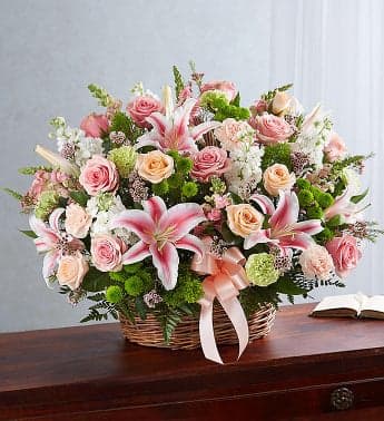 Pastel Basket  - Our pastel basket arrangement. Handcrafted by expert florists with a soft, delicate gathering of blooms, this piece is typically sent to the funeral home, and can later be brought home by a close family member, offering peace and comfort to them when they need it most.