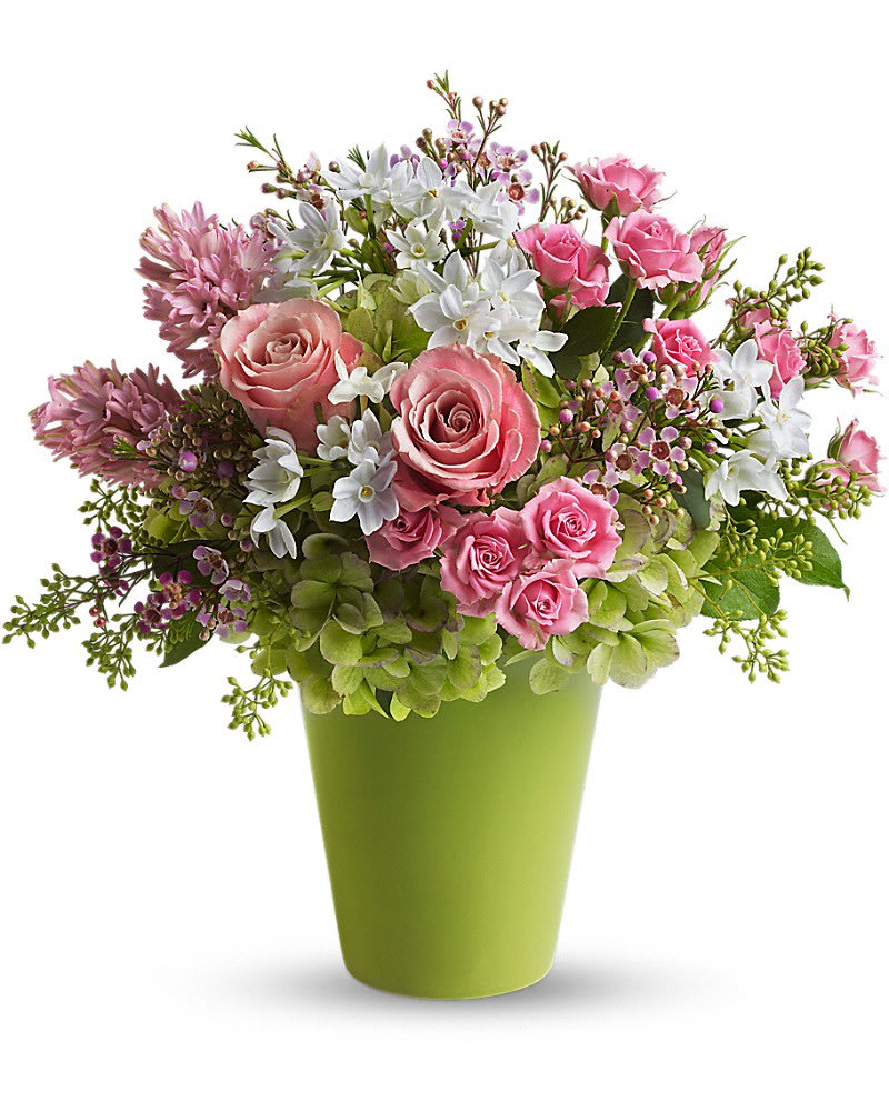 Enchanted Blooms Enchanted Blooms - If fairy tales were made of flowers undoubtedly this is what they'd look like. Charming fresh and fabulous these enchanted blooms are sure to cast a magical spell. Dazzling green hydrangea pink roses spray roses hyacinth and waxflower white narcissus and spring greens are delivered in a bright green cylinder container.
