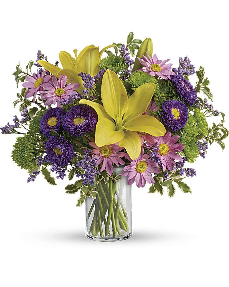 Teleflora's Fresh And Fabulous Bouquet - Sprinkle happiness on any occasion with this bright beautiful bouquet! A cheerful blend of sunshiny lilies pretty purple blooms and glowing greens in a classic cylinder it makes any day feel fresh and fabulous! This fabulous bouquet includes yellow asiatic lilies purple matsumoto asters green cushion spray chrysanthemums lavender daisy spray chrysanthemums purple limonium and pitta negra. Delivered in a glass cylinder vase.