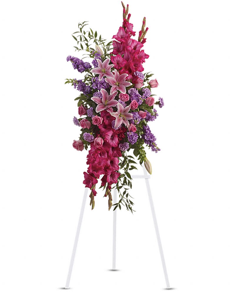 Touching Tribute Spray - Express admiration for her beauty and spirit with a striking tribute certain to evoke many cherished remembrances. Gorgeous flowers such as pink roses oriental lilies and gladioli blend with purple stock lavender carnations and fragrant greens.