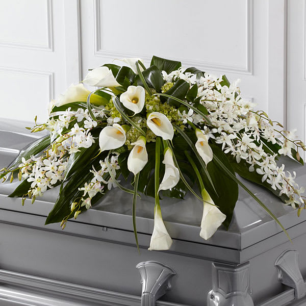 The FTD Angel Wings Casket Spray The FTD Angel Wings Casket Spray - The FTD® Angel Wings™ Casket Spray is an exceptionally gorgeous way to bring peace and beauty to their final farewell service. White Dendrobium orchids white calla lilies green hydrangea and a variety of lush greens are artfully arranged to perfectly adorn the top of their casket offering the colors and ambience of grace and serenity.