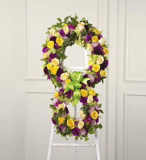 Eternity Standing Easel(FTD) Eternity Standing Easel(FTD) - The soul’s passage into the hereafter is celebrated with this inspiring floral tribute handcrafted by a local FTD artisan florist to reflect the symbol of “infinity.” The two conjoined wreaths are constructed of yellow roses fuchsia and purple carnations fuchsia dianthus lavender pompons and golden solidago accented with lush greens and trimmed with coordinating ribbon. It’s a powerful and lovely statement of faith that is sure to console and comfort all who share your loss.