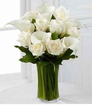 The FTD® Sweet Solace™ Bouquet - The FTD® Sweet Solace™ Bouquet is a divinely elegant arrangement that encourages peace and offers your sympathy. Brilliant white roses and calla lilies are simply set amongst lush greens in a clear glass gathering vase to create a meaningful gift that will help your special recipient through this trying time of grief and loss. GOOD bouquet includes 13 stems. Approximately 15&quot; x 13&quot;W. BETTER bouquet includes 17 stems. Approximately 16&quot;H x 13&quot;W. BEST bouquet includes 21 stems. Approximately 19&quot;H x 15&quot;W. Your purchase includes a complimentary personalized gift message.