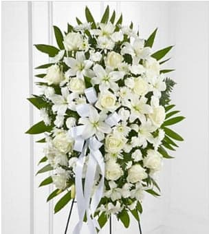 The FTD® Exquisite Tribute™ Standing Spray - The FTD® Exquisite Tribute™ Standing Spray is an elegant display of sweet serenity. White roses, Asiatic lilies, chrysanthemums and mini carnations are artfully arranged amongst emerald palm fronds and lush greens. Accented by white satin ribbon and standing on a wire easel, this standing spray is an outstanding way to honor the life of your loved one. BETTER spray is approximately 33&quot;H x 21&quot;W. Your purchase includes a complimentary personalized gift message.