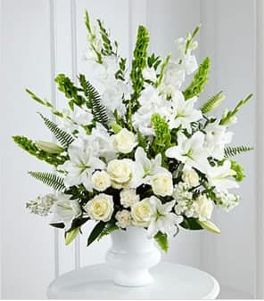 The FTD® Morning Stars™ Arrangement The FTD® Morning Stars™ Arrangement - The FTD® Morning Stars™ Arrangment is a brilliant expression of peace and soft serenity. White roses, carnations, gladiolus, stock and Oriental lilies are accented with the bright green stems of Bells of Ireland and a gorgeous assortment of lush greens, while seated in a designer plastic urn to create a beautiful way to honor the life of the deceased. GOOD arrangement includes 31 stems. Approximately 36"H x 30"W. BETTER arrangement includes 43 stems. Approximately 40"H x 32"W. BEST arrangement includes 55 stems. Approximately 45"H x 36"W. Your purchase includes a complimentary personalized gift message.