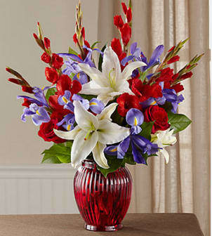 The FTD® Loyal Heart™ Bouquet - Celebrate a life dedicated to the love of country with a vibrant bouquet of red, white and blue blossoms beautifully hand-arranged by an FTD local artisan florist. This bright and beautiful tribute evokes loving memories of the deceased's devotion to the nation−in the armed forces, as a government worker or as a public spirited patriot. Its red roses, white gladiolus and Oriental lilies, and blue irises beautifully reflect the colors of their beloved flag and are arranged in a classic vase of ruby red glass. It is sure to be long remembered at a wake, funeral service or for offering your condolences at the home of grieving family and friends.  GOOD arrangement includes 17 stems. Approximately 21&quot;H x 17&quot;W.   BETTER arrangement includes 22 stems. Approximately 23&quot;H x 19&quot;W.   BEST arrangement includes 27 stems. Approximately 24&quot;H x 20&quot;W. Your purchase includes a complimentary personalized gift message.