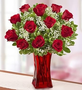 Blooming Love Premium 12 Red Roses in Red Vase Blooming Love Premium 12 Red Roses in Red Vase - EXCLUSIVE Whether you're looking to get the attention of a certain someone or letting her know she's the one, you can't go wrong with a classic. One dozen premium long-stem red roses are hand-designed by our expert florists and arranged with love in a ruby red vase to help your express your feelings in the most romantic way possible.