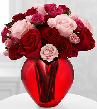 My Heart to Yours Rose Bouquet  - The My Heart to Yours Rose Bouquet by FTG blooms with an array of roses and spray roses to give your sweetheart a rush of romance! Pink roses and red roses are brought together with hot pink spray roses, light pink spray roses and red spray roses to form an eye-catching flower bouquet. Presented in a designer red glass heart-shaped vase, this flower arrangement will make a day filled with love and passion they will always hold dear in their heart. 
