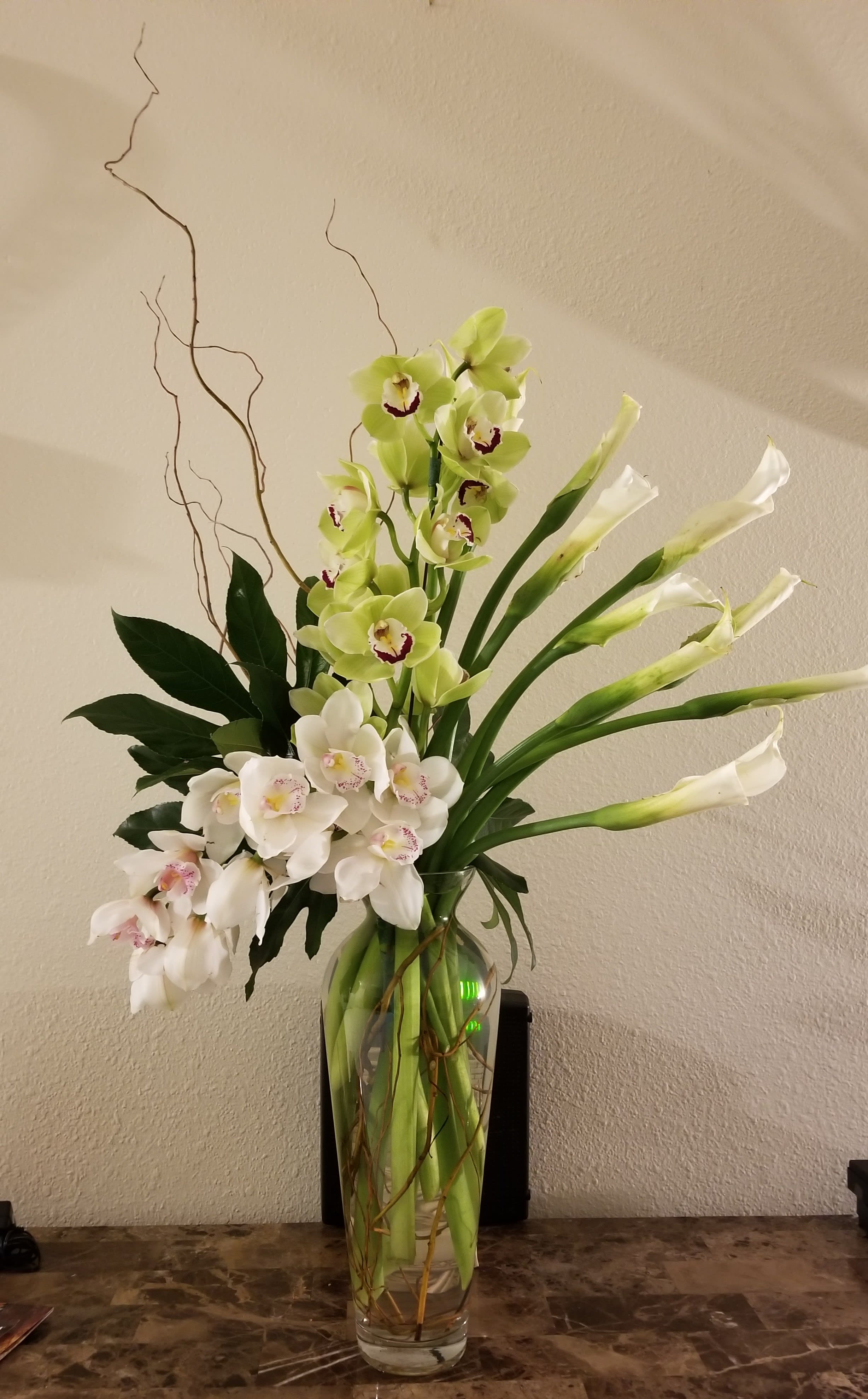 Orchids &amp; Calla Liles - Elegant arrangement of orchids and calla liles with some curly willow.