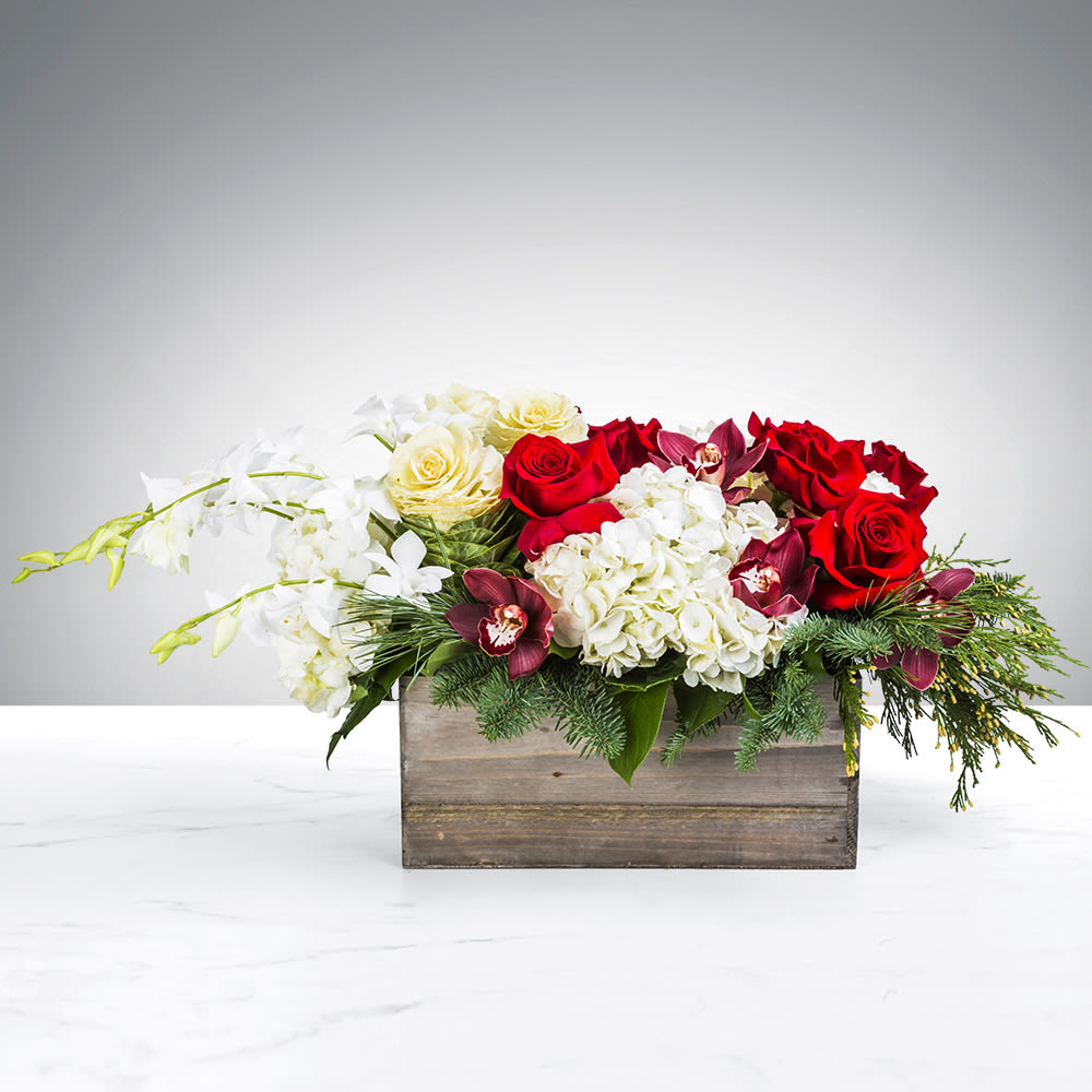 Snowman’s Scarf By BloomNation™ - A snowman’s life is short and sweet. He treasures every second of it. Remind yourself to celebrate the short and sweet moments in life with this Snowman’s Scarf. Sidenote: please do not physically use this flower arrangement as a makeshift scarf.