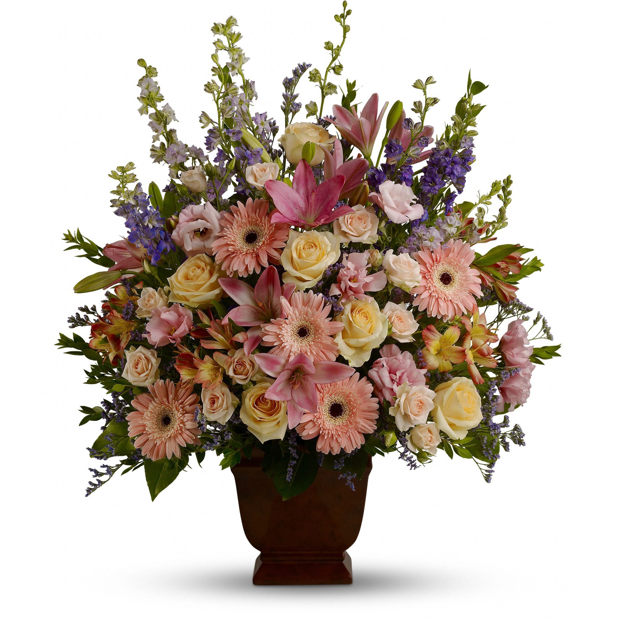 Teleflora's Loving Grace - A warm and peaceful bounty of pastel blossoms gently expresses love and respect. A gracefully composed arrangement appropriate for home or service.  