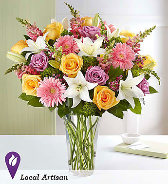 Sensational Spring Beauty™ -  Bright yellow and lavender roses, pink and yellow snapdragons, and much more boldly announce: “Spring is here... and it’s sensational!”