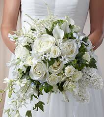  Cherish™ Bouquet -  Blossoming with a blend of white blooms, including roses, mini calla lilies, sweet pea, astilbe, trick dianthus, hyacinth, dendrobium orchids, spray roses, and hydrangea, this stunning arrangement is accented with variegated ivy vines to add to the cascade shape of this remarkable bouquet.