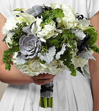 Sweet Innocence™ Bouquet ( Flower Girl) - White mini calla lilies, double lisianthus, and hydrangea create the perfect back ground for the green accent pieces of dianthus, brunia, fern, Dusty Miller stems, and succulents to truly pop. Hand-tied together into a sweet posy bouquet with the stems wrapped in silver taffeta and black taffeta ribbons, your flower girl is on trend and ready to show off her amazing style with this exquisite flower arrangement.