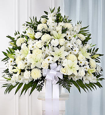 Heartfelt Sympathies™ Standing Basket- White - Symbolizing peace, serenity and purity, white flowers can help comfort those grieving the loss of someone they loved dearly. Our majestic standing basket arrangement in angelic white is an impressive tribute to their memory. Artistically designed by expert florists with an abundance of pristine white blooms, it is a heartfelt expression of your deepest sympathies.