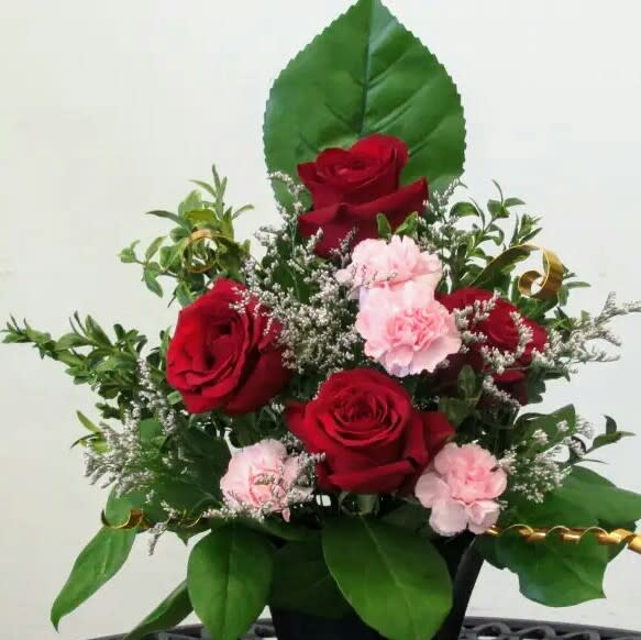 Short and Sweet  - Pink and red design with a combination of pink and red roses , carnations , and greens.