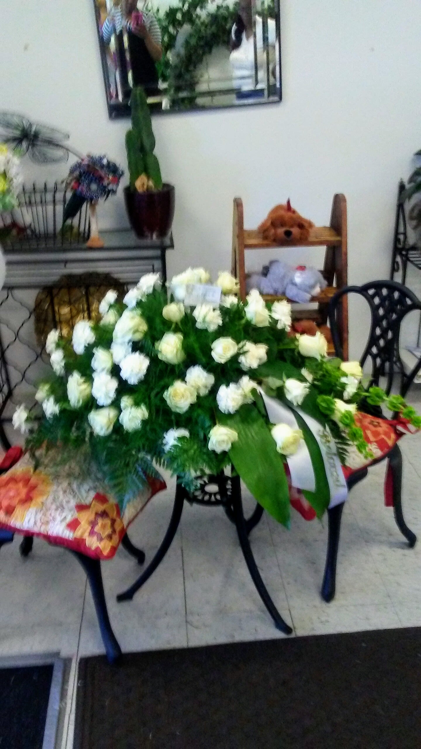 Gone to soon  casket spray - White roses carnations and assorted greens
