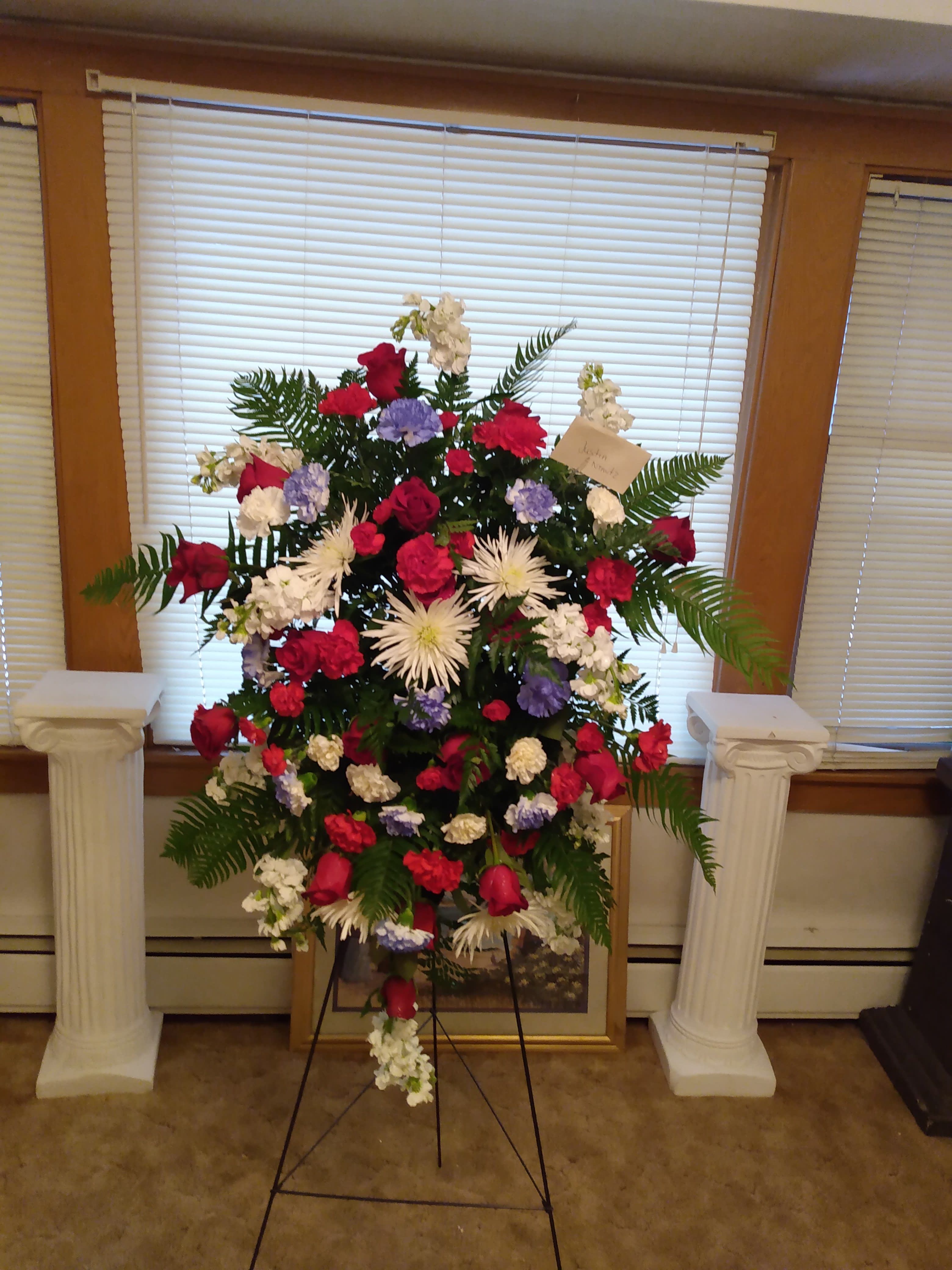 A true patriot - Sandlot the person you love with a beautiful red white and blue standing spray with carnations spider mums and roses