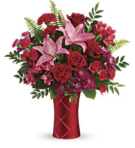Satin Kisses - Send kisses soft as satin with this romantic bouquet! Artfully arranged in a shimmering, satin-finish ceramic vase with pretty quilted texture, this mix of red roses and pink lilies is sure to take their breath away.