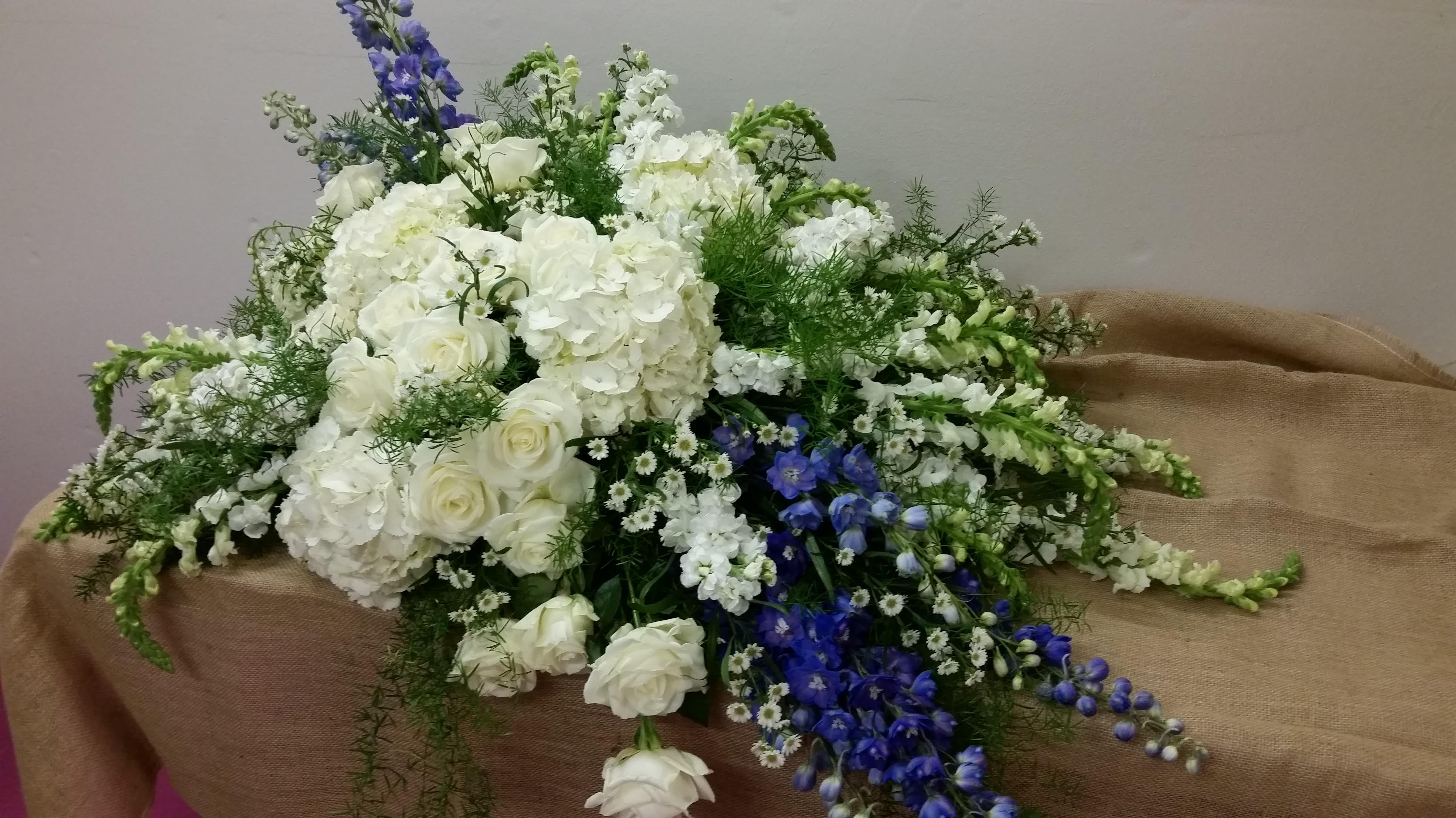 Deluxe Casket Spray in Stevensville, MT Peacock Floral