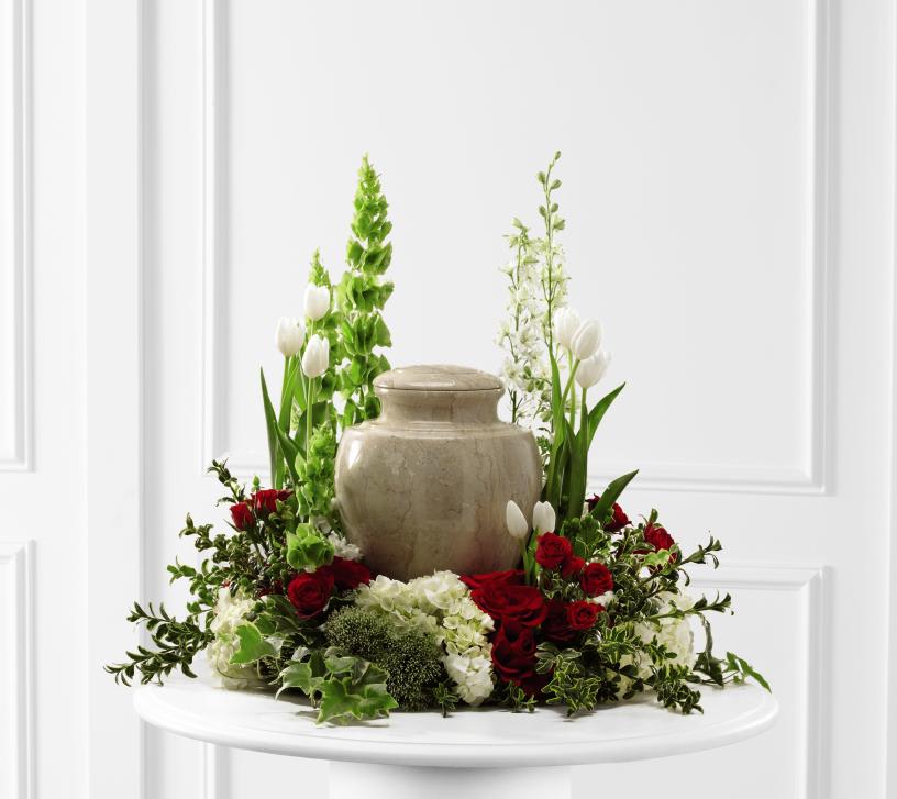 FTD Tears of Comfort Arrangement - The FTD Tears of Comfort Arrangement is an elegant and  sophisticated way to surround their urn with floral beauty at the final  farewell service. Rich red roses and spray roses are vivid and bright  arranged amongst white tulips, larkspur, hydrangea, and trachelium,  accented with the bright greens of Bells of Ireland, hypericum berries,  ivy and myrtle, creating a wonderful way to honor the life of the  deceased.   21&quot;&quot;h x 24&quot;&quot;w &quot;