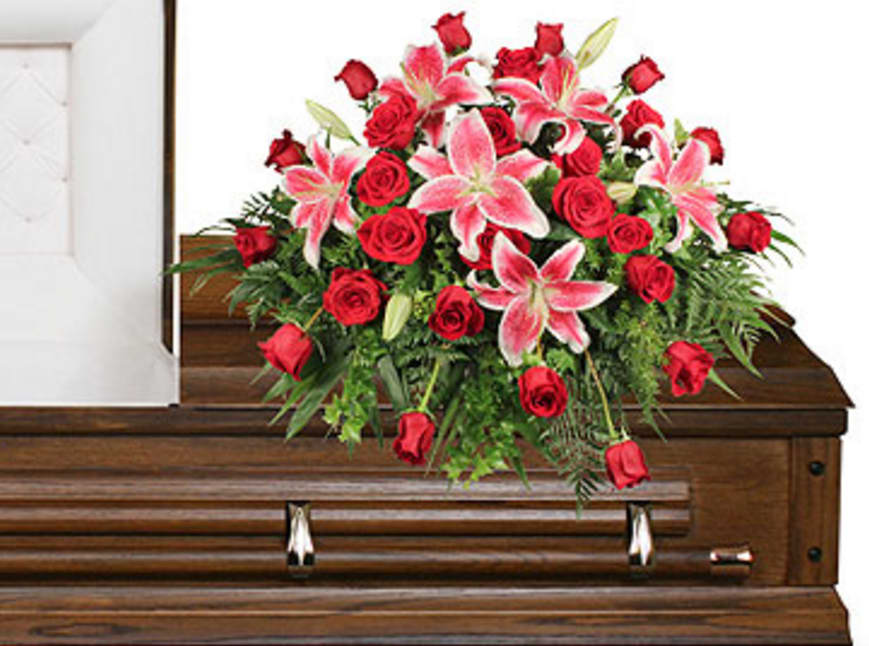 CF2107 - Dedication of Love Dedication of Love features a lush assortment of Jade, Leather Leaf, Ivy, Sprengeri, Variegated Pittosporum, Red &amp; White Lilies (Starfighter), and Red Roses.  Copyrighted content provided by FlowerShopNetwork.com Proud Member of Flower Shop Network