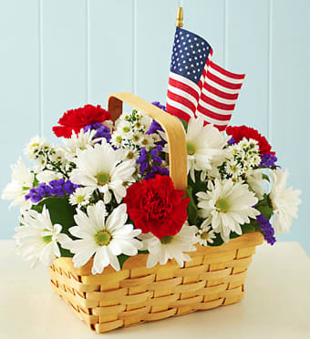 CF2080 - Red, White, &amp; Blooms Send a patriotic salute to make someone smile! Our all-American basket arrangement of fresh red carnations, white daisy poms and purple statice is hand-gathered by our expert florists and accented with a mini American flag. This bouquet brings a truly original touch to Memorial Day barbecues, 4th of July picnics or any summertime celebration with family and friends.