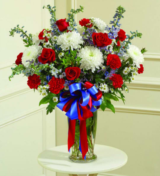 BNPT4 - Red, White &amp; Blue Sympathy Vase Send your sincerest sympathy to someone through patriotic beauty with this Red, White &amp; Blue Sympathy Vase arrangement. Roses, mums, carnations and stock-matthiola adorn this arrangement and make it a truly special piece filled with honor and pride. 