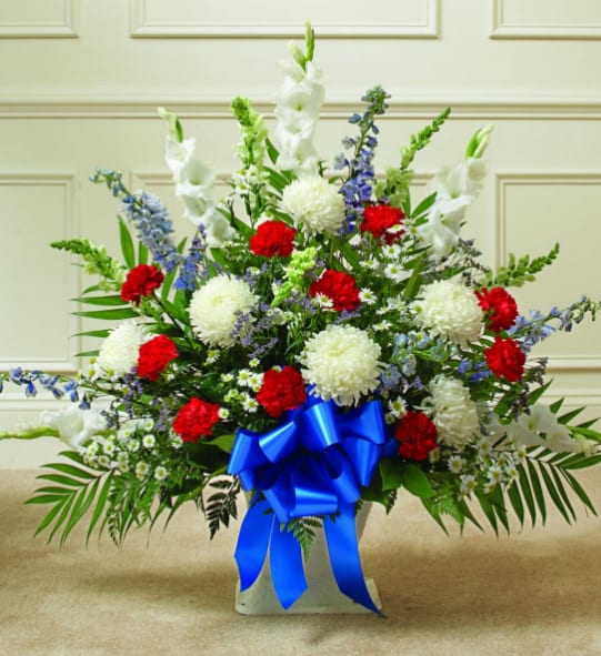 BNPT7 - Red, White &amp; Blue Sympathy Floor Basket Our patriotic Red, White &amp; Blue Sympathy Floor Basket is a remarkable and respectful way to honor a loved one. The symbolic colors of this artistically crafted arrangement will extend your most sincere and heartfelt condolences. This one-sided, fan-shaped arrangement will rest elegantly on the floor in the most beautiful way.