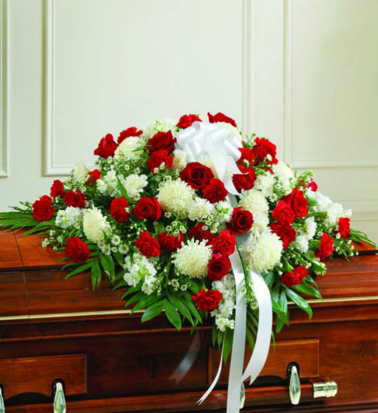 BNRD4 - Red &amp; White Sympathy Casket Spray A meaningful and sincere way to honor a loved one, is with an elegant half casket spray.  Exquisite red and white flowers elegantly drape the casket, while serving as a beautiful tribute during their final service. 