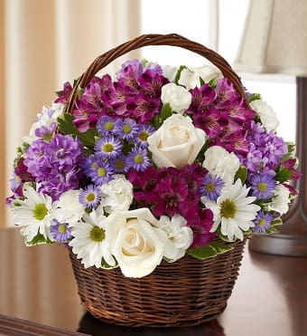 95425 - Peace, Prayers, &amp; Blessings- Lavender and White Express your heartfelt sympathy with a graceful arrangement of peaceful lavender and white blooms such as roses, stock, alstroemeria and more. Designed by hand in a lovely basket, it's a beautiful tribute to a life well lived.