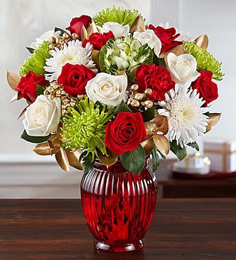 BN148878 - Majestic Christmas Bouquet  Share the joy of Christmas with our luxurious, full-bodied bouquet, filled with elegant long-stem red and white roses, cheerful green spider mums, captivating gold-tinted ruscus and hypericum and more! These beautiful blooms make for a rustic combination of color and texture. For a truly unforgettable holiday surprise, add our festive red or clear glass ginger jar vase.