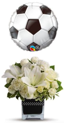 Soccer Celebration - Surprise your favorite soccer fan with this lush bouquet and balloon. This elegant bouquet includes white Asiatic lilies, white carnations, white roses, white button spray chrysanthemums and white spray roses accented with fresh greenery. Delivered in a black contemporary glass cube vase decorated with a black and white polka dot ribbon.  Product Code: TFWEB612